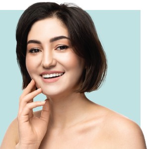 A woman touching her face happy with her classic facial.
